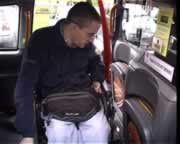 Still from the movie clip: Neil prepares to leave the cab backwards